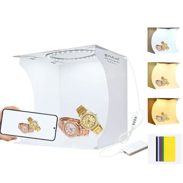 Kit de studio photo portable pliable avec panneau LED annulaire PULUZ de 23 cm, comprenant une tente et 6 fonds de couleur (noir, blanc, jaune, rouge, vert, bleu). Dimensions déplié : 24 cm x 23 cm x 23 cm. Panneau LED annulaire de 23 cm.