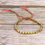 Bijou bracelet tissé main perles de cuivre irrégulières, mat, léger, corde rouge clair