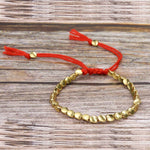Bijou bracelet tissé main perles de cuivre irrégulières, mat, léger, corde rouge clair