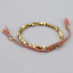 Bijou bracelet tissé main perles de cuivre irrégulières, mat, léger, corde rouge clair