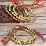 Bijou bracelet tissé main perles de cuivre irrégulières, mat, léger, corde rouge clair