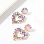 Boucles d'oreilles clou Amour Aiguille d'Argent, E2109-12 Diamant violet, E2109-13 Diamant blanc, E2112-9 Amour asymétrique or, E2112-10 Amour asymétrique K blanc