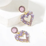 Boucles d'oreilles clou Amour Aiguille d'Argent, E2109-12 Diamant violet, E2109-13 Diamant blanc, E2112-9 Amour asymétrique or, E2112-10 Amour asymétrique K blanc