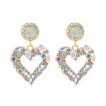 Boucles d'oreilles clou Amour Aiguille d'Argent, E2109-12 Diamant violet, E2109-13 Diamant blanc, E2112-9 Amour asymétrique or, E2112-10 Amour asymétrique K blanc