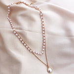 Collier à pendentif double rang de perles et perles simples