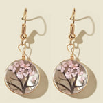 Boucles d'oreilles faites à la main en verre avec fleurs séchées et gypsophiles