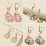 Boucles d'oreilles faites à la main en verre avec fleurs séchées et gypsophiles